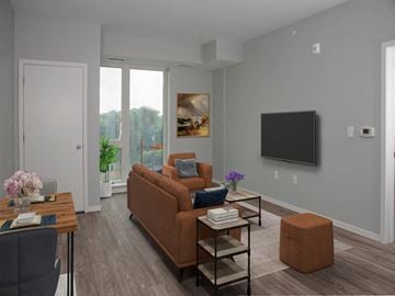 St. Paul apartment for rent - A living room with a brown couch, a coffee table, and a painting on the wall.