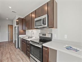 St. Paul apartment for rent - A Kitchen with Brown Cabinets at Nova SP Apartments, St. Paul, 55130