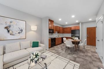 St. Paul apartment for rent - A modern living room with a white couch and a coffee table with flowers on it.