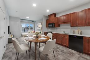 St. Paul apartment for rent - A modern kitchen with a dining table set for four at Soul Apartments, Minnesota