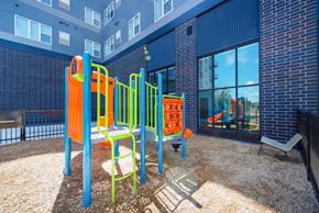 St. Paul apartment for rent - A playground with a slide, swings, and a climbing frame at Soul Apartments, Minnesota 55107