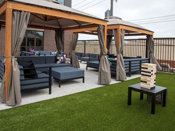 Upii outdoor lounge seating with oversized outdoor jenga and cabanas
