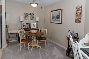 Saint Paul apartment for rent - a dining room with a table and chairs and a window