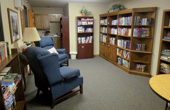 A living room filled with furniture and a bookcase