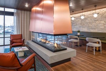 A living room filled with furniture and a large fireplace