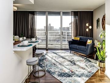 Lincoln apartment for rent - a living room with a couch and a table and a balcony