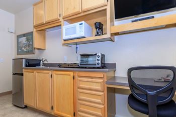 A kitchen with a black chair