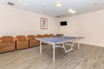 A ping pong table in the middle of a room 