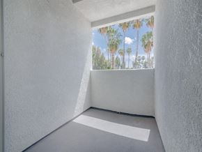 Canoga Park apartment for rent - a view of palm trees from a window in a white room at Warner Center Townhomes, California