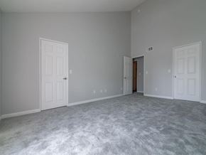 Canoga Park apartment for rent - a bedroom with a carpeted floor and two doors at Warner Center Townhomes, California