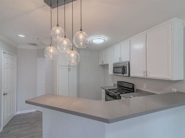 Canoga Park apartment for rent - a kitchen with white cabinets and a counter top at Warner Center Townhomes, Canoga Park, CA 91303