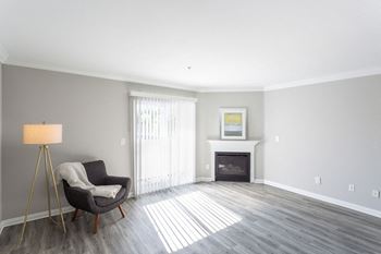 A living room with a chair and a fireplace