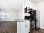 Daly City apartment for rent - an empty kitchen with a stove refrigerator and microwave at Skyline Heights Apartments, Daly City