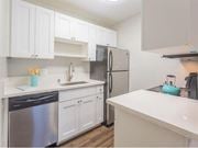 Daly City apartment for rent - a kitchen with white cabinets and a stainless steel refrigerator at Skyline Heights Apartments, California, 94015