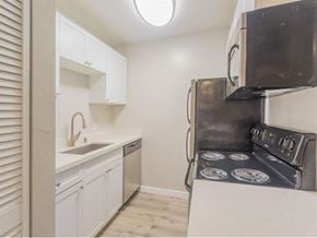 Daly City apartment for rent - a kitchen with a stove and a sink and a microwave at Skyline Heights Apartments, Daly City, 94015
