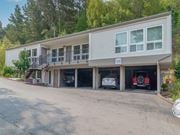 Mill Valley apartment for rent - a large building with cars parked in the garage at Trailhead Apartments at Tam Junction, Mill Valley California