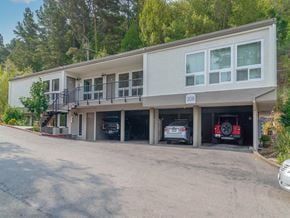 Mill Valley apartment for rent - a large building with cars parked in the garage at Trailhead Apartments at Tam Junction, Mill Valley California