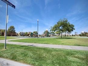 Oxnard apartment for rent - a park with a playground and a street sign at The Vines at Riverpark, LLC, California