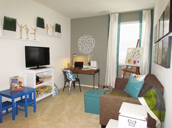 Oxnard apartment for rent - a living room with a couch and a desk and a tv at The Vines at Riverpark, LLC, Oxnard
