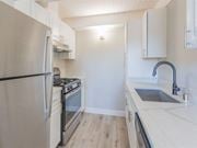 San Mateo apartment for rent - a kitchen with white cabinets and a stainless steel refrigerator  at The Preston at Hillsdale, San Mateo, CA
