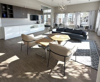 A living room and kitchen with a table and chairs