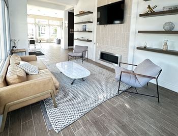A living room with a couch and a table and a television