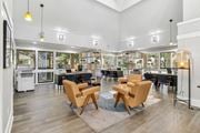 Santa Clara apartment for rent - a living room with chairs and tables and a library at Summerwood Apartments, Santa Clara, CA