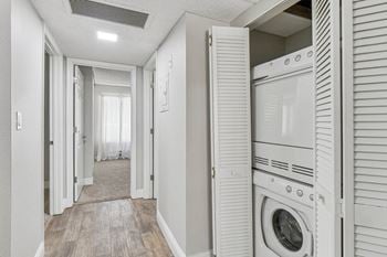 A washer and dryer in a laundry room with a closet