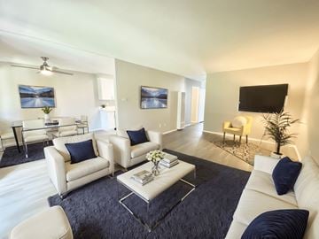 Tarzana apartment for rent - A living room with white furniture and a black flat screen TV.