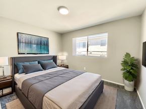 Tarzana apartment for rent - A bedroom with a large bed and a painting on the wall.