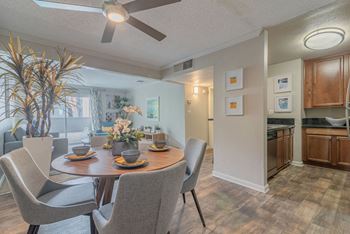 A dining room and kitchen with a table and chairs