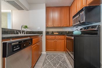 A kitchen with stainless steel appliances and wooden cabinets