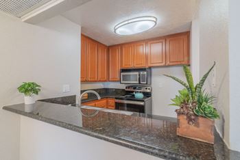 A kitchen with a granite counter top and