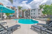 Woodland Hills apartment for rent - our apartments have a large swimming pool and lounge areas with umbrellas at City View Apartments at Warner Center, Woodland Hills, CA