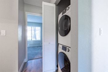 A washer and dryer in a laundry room with a window