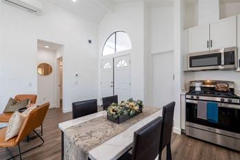 A kitchen and dining room with a table and chairs