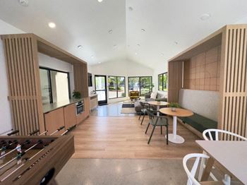 A kitchen and living room with a table and chairs