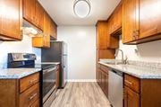 Sunnyvale apartment for rent - a kitchen with wooden cabinets and stainless steel appliances at Element LLC, Sunnyvale