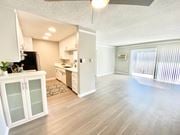 Sherman Oaks apartment for rent - an empty living room and kitchen with a sliding glass door at The Flats on Addison, Sherman Oaks, CA