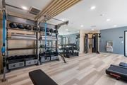 San Diego apartment for rent - A gym with a variety of equipment including weights and a treadmill at Latitude Apartments at Mission Valley Apartments, San Diego, 92120