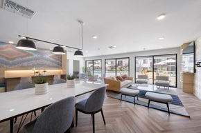 San Diego apartment for rent - A modern dining area with a long table and chairs at Latitude Apartments at Mission Valley Apartments, San Diego