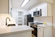 Santa Clara apartment for rent - A kitchen with white cabinets and black appliances at Summerwood Apartment , California, 95050