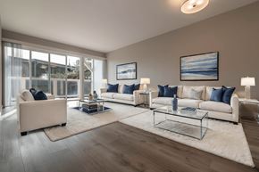 Sausalito apartment for rent - A living room with a large window, a white sofa, a glass coffee table, and a rug at The Pier at Sausalito, Sausalito, CA