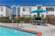 El Cajon apartment for rent - our apartments have a swimming pool and a patio with a table and umbrellaat The Arches Apartments, LLC, El Cajon California