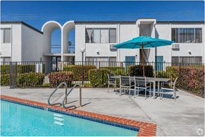 El Cajon apartment for rent - our apartments have a swimming pool and a patio with a table and umbrellaat The Arches Apartments, LLC, El Cajon California