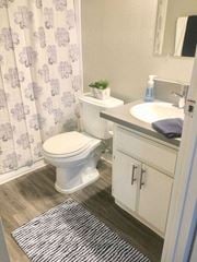 Los Angeles apartment for rent - a bathroom with a toilet and a sink and a shower curtain  at The Marq Apartments LLC, Los Angeles