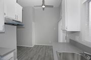 Los Angeles apartment for rent - a kitchen with white cabinets and a ceiling fan  at The Marq Apartments LLC, Los Angeles, California