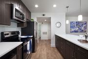 Yorba Linda apartment for rent - a kitchen with white counter tops and black appliances at The Bryant, Yorba Linda, CA 92887