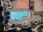 Yorba Linda apartment for rent - an aerial view of a swimming pool at a resort with umbrellas and chairs at The Bryant, California