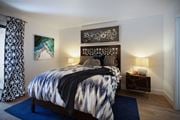 Yorba Linda apartment for rent - a bedroom with a bed and a blue rug at The Bryant, Yorba Linda, CA